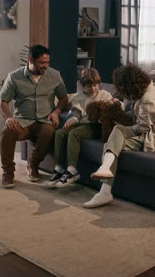 Family bonding with cute puppy in living room