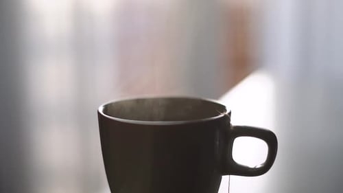 Steaming Cup of tea, Brown mug, close up