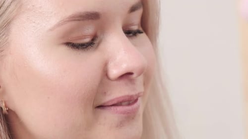 Woman Smiles While Getting Hair Bleached