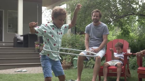 Of Boy Playing with Plastic Hoop in Garden