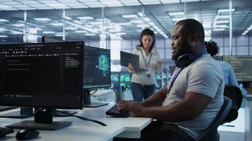 Teamworking Colleagues Updating AI Systems on PC and Laptop