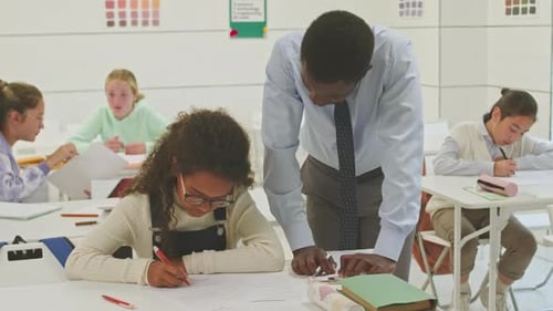 Teacher Helping Student in Classroom Setting
