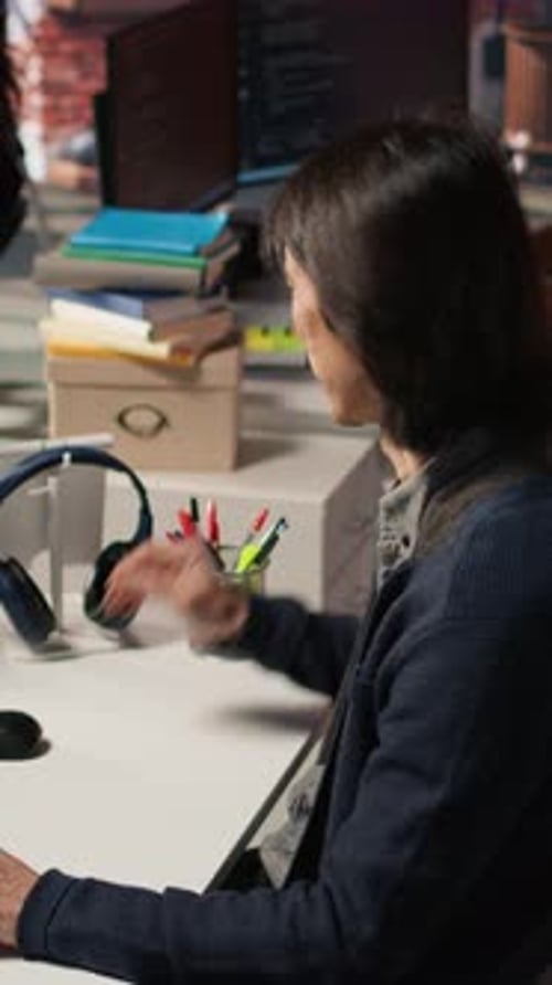 Vertical Video Senior Programmer in AI Startup Office Putting on Headphones