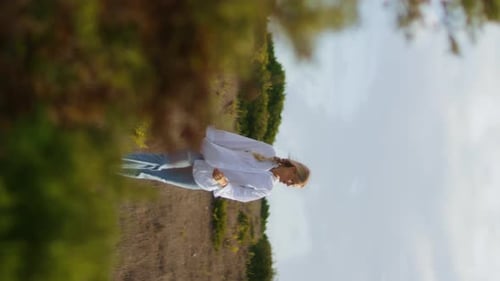 Woman Walking Through a Rural Field