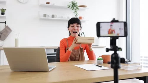Woman Unboxing New Mobile Phone On Social Media