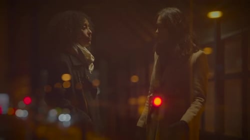 Young Adults Chatting on City Street at Night