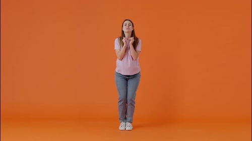 Scared Woman Pleading and Clasping Hands in Studio