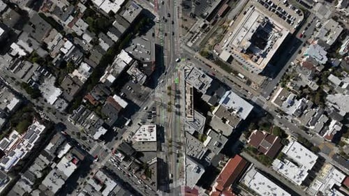 Fly High Above City Top Down Footage of Traffic in Streets and Vehicles Passing Through