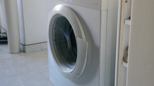 Man Opens Washing Door Side View Doing Laundry at Home Detail Shot Unrecognizable Person