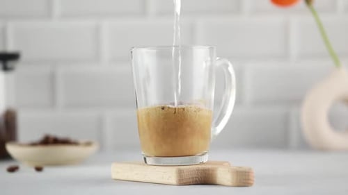 Instant Coffee Preparation with Hot Water in Kitchen