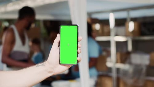 Person Holds Cellphone with Green Screen