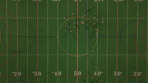 American Football Teams of Play at Night Time Aerial Top Down Wide Shot Footage