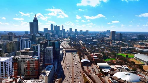 Wide multi-lane road going along Atlanta downtown. Scenic view of American metropolis on sunny day