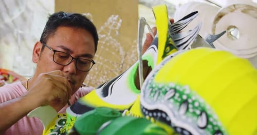 One Of The Last Paper Dragon Masters Of Hong Kong, Painting Design Onto Hand Made Dragon. Slow Mo...