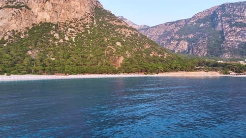Picturesque Beach with Mountain Backdrop Aerial View