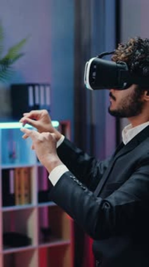 Young adult using VR goggles in office setting