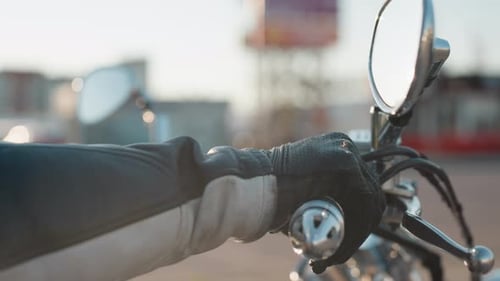 Rider Hand Gripping Motorcycle Handle in Leather Glove