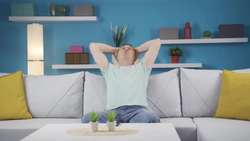 Frustrated Man Sitting on Couch at Home