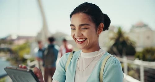 Smiling Young Woman Using Tablet Device Outdoors