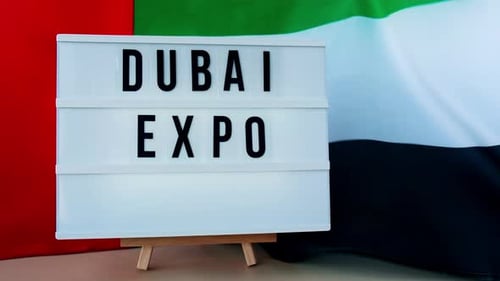 Dubai Expo Sign with Waving Flag