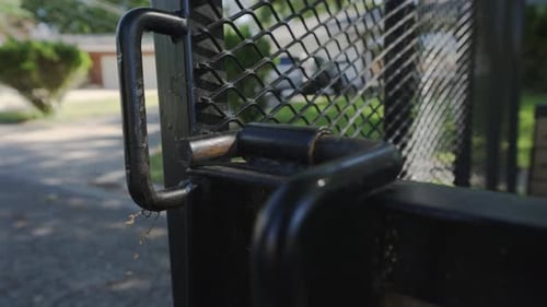 Lowering the metal safety gate on a trailer.