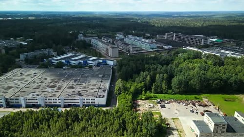 Aerial View of an Industrial Complex Set in a Lush Forest Highlighting the Harmony Between Industry