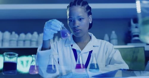 Professional biochemist testing various fluids and analyzing the results for her chemical testing