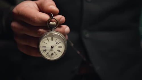 Mann hält Taschenuhr in der Hand