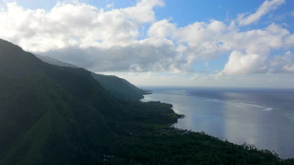 Morning sunrise clouds volcano island mountains Teahupoo Tahiti aerial ...