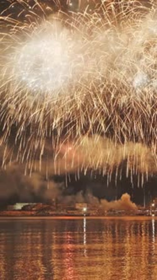 Fireworks with colorful lights over sea