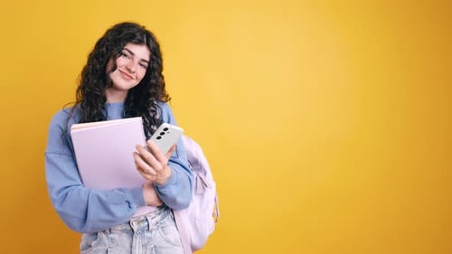 Young Woman with Phone and Notebook Smiling