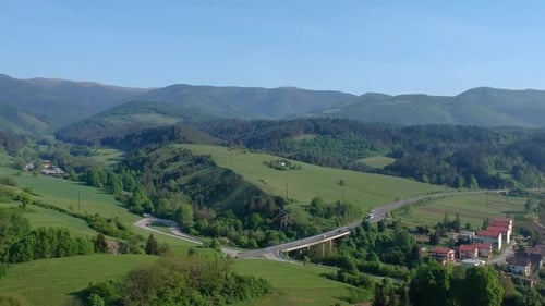 Aerial shot of beautiful green nature landscape, a mountain range covered in trees