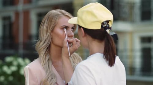 Close Up Make Up Artist Doing Professional Face Make Up Outdoor. Stylist Woman Doing Makeover Wit...