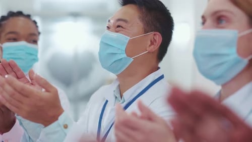 Medical Professionals Clapping in Hospital Wearing Face Masks