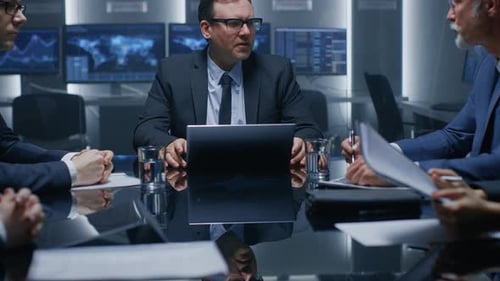 Serious Business Meeting at Conference Table in Modern Office