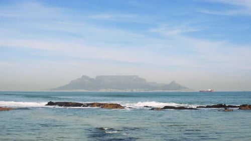A ship lays at anchor in Table Bay on a perfect Cape Town morning.
