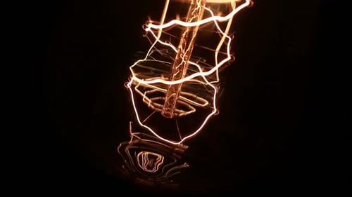 Light Bulb Filament Glowing in the Dark