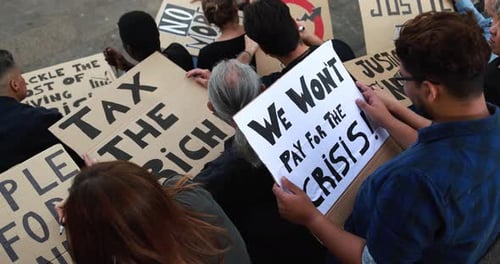 Crowd of multiracial people prepare banners against inflation and financial crisis