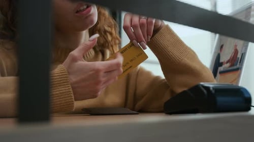 Woman Holding Credit Card at Counter in Bank Office