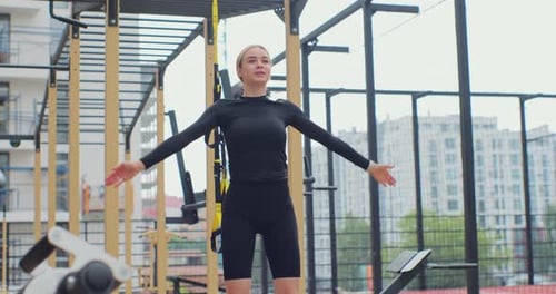 Woman Exercising Doing Jumping Jacks in Urban Gym