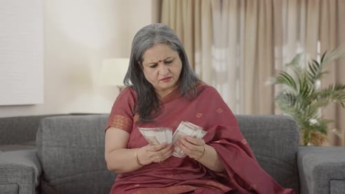 Indian old woman counting money