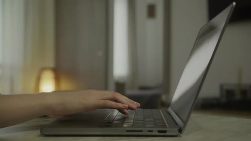 Hands Typing on Laptop Keyboard Close Up