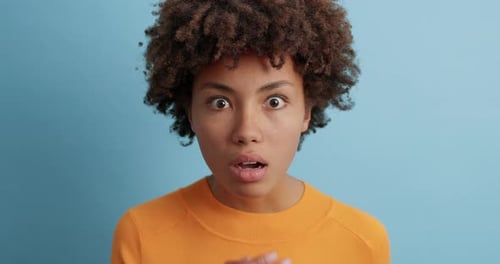 Surprised Woman Looking Intently With Wide Eyes and Gaping Mouth