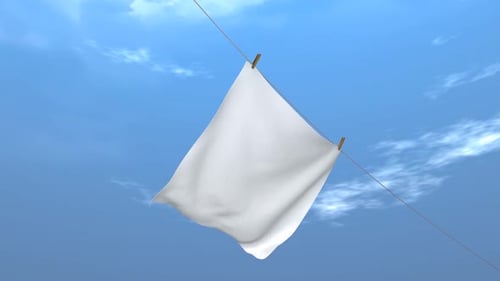 White Cloth Billowing on Clothesline Against Blue Sky