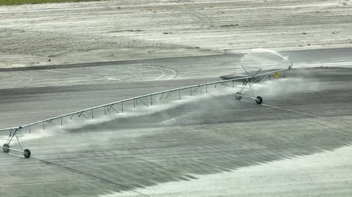 Sprinkler Irrigation System Watering Farm Field During Dry Season