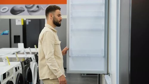 Customer Evaluating Refrigerator Features in Appliance Store