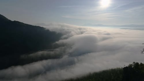 Sun Shining Over a Valley Filled with Fog