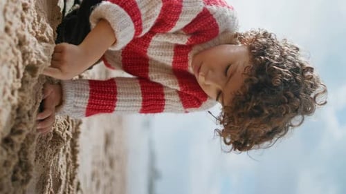 Cute Boy Building Sand Figures at Ocean Shore Focused Child Rest Vertically