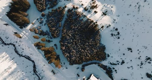 Top View Drone Flies Above Idyllic Winter Ski Resort Village Buildings and Snowy Mountains Landscape