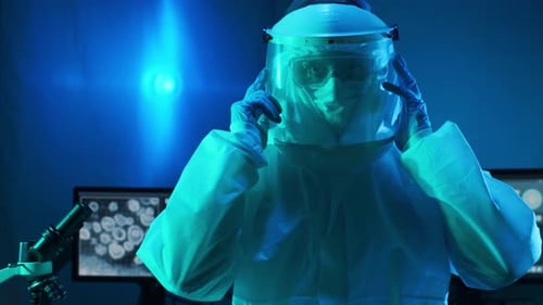 Scientist Adjusting Protective Visor in Laboratory